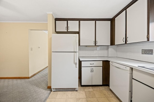 kitchen with white appliances, light countertops, light colored carpet, tasteful backsplash, and crown molding