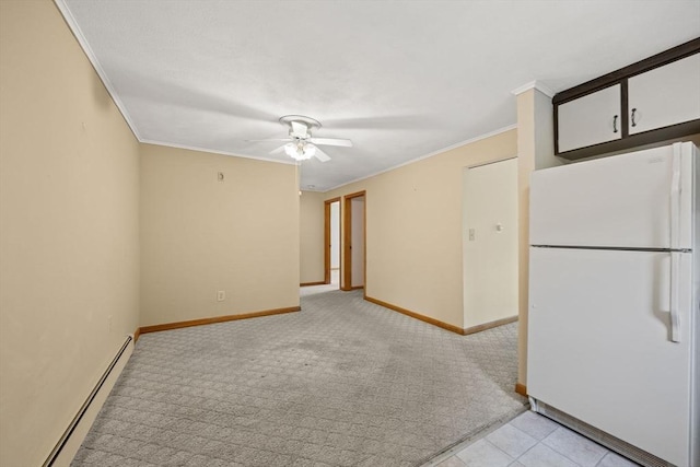 unfurnished room with a baseboard heating unit, light colored carpet, ceiling fan, crown molding, and baseboards