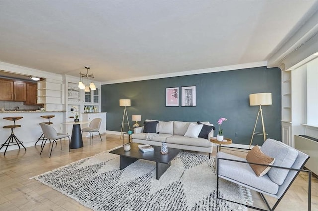 6 Whittier Pl Unit 10H, Boston, MA 02114 - living room with ornamental molding, baseboards, built in shelves, a chandelier, and radiator