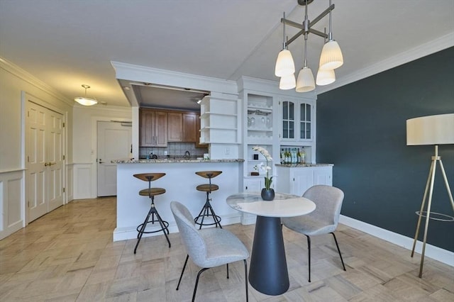 6 Whittier Pl Unit 10H, Boston, MA 02114 - dining area with ornamental molding and a chandelier
