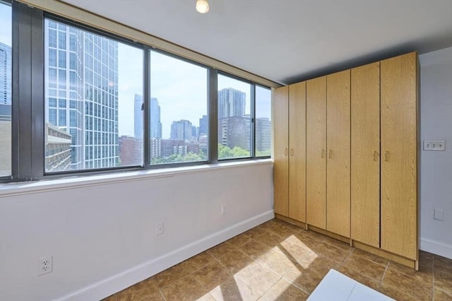 6 Whittier Pl Unit 10H, Boston, MA 02114 - unfurnished bedroom with baseboards and a view of skyline
