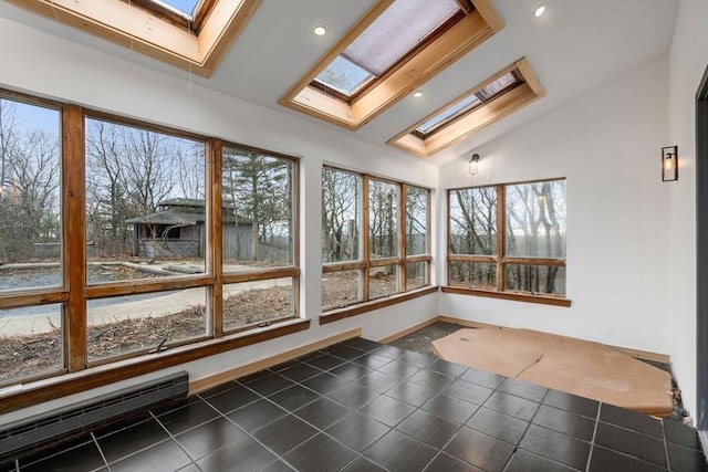 unfurnished sunroom with vaulted ceiling with skylight and baseboard heating