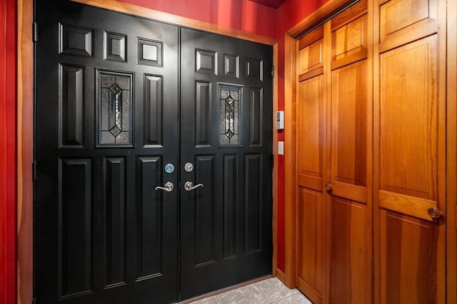 foyer entrance featuring light tile patterned flooring