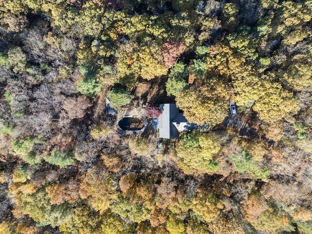 drone / aerial view with a wooded view