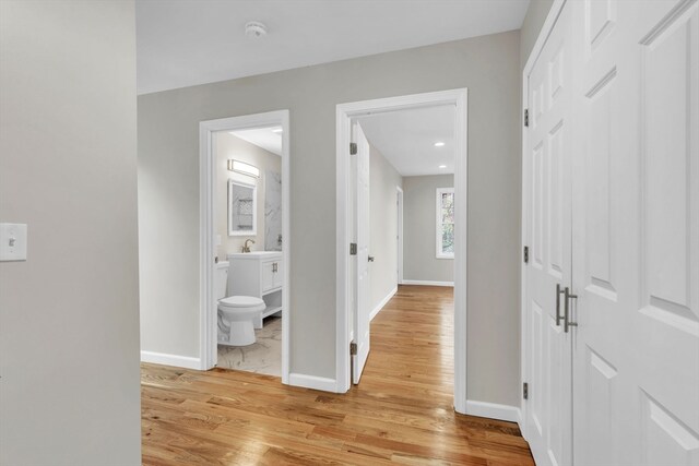 corridor with light hardwood / wood-style floors