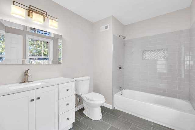 full bathroom with vanity, toilet, and tiled shower / bath combo