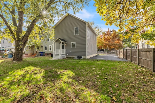 rear view of house with a yard