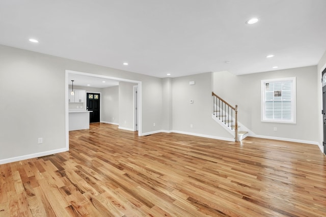 unfurnished living room featuring light wood-type flooring