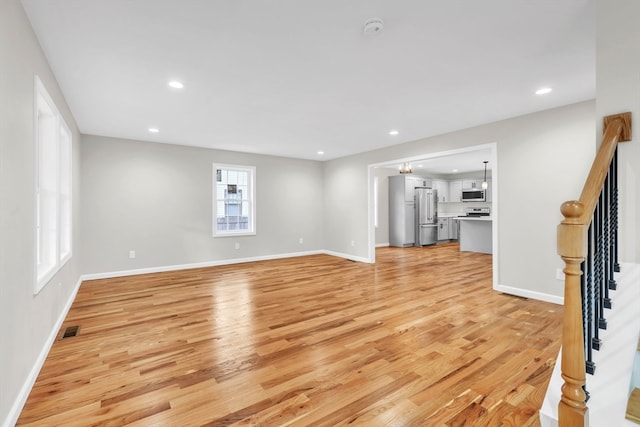 unfurnished living room featuring light hardwood / wood-style flooring