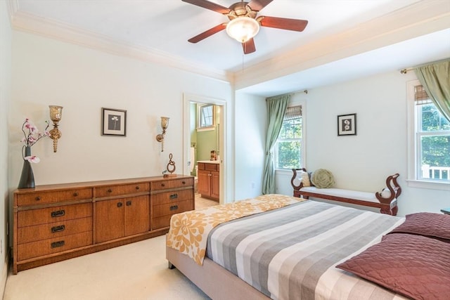 bedroom featuring light carpet, multiple windows, crown molding, and connected bathroom
