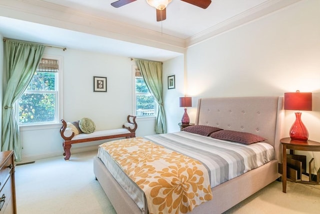 bedroom with ceiling fan, baseboards, crown molding, and carpet floors
