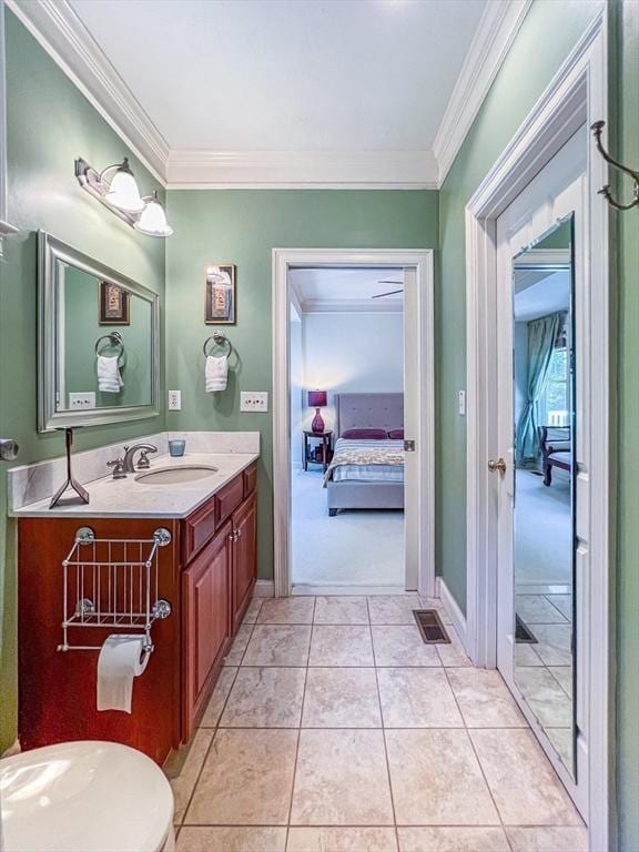 bathroom with visible vents, ensuite bathroom, crown molding, vanity, and tile patterned flooring