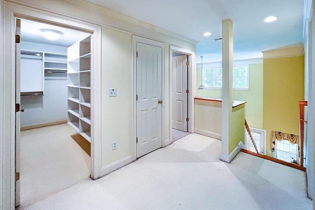 hall featuring carpet floors, baseboards, an upstairs landing, and recessed lighting