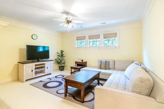 living room featuring ceiling fan, ornamental molding, visible vents, carpet flooring, and baseboards
