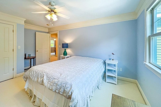 bedroom with ornamental molding, baseboards, ceiling fan, and light carpet