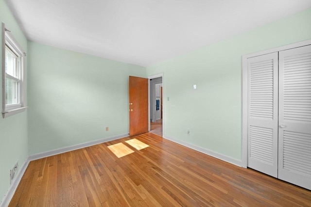 301 Main St, Acushnet, MA 02743 - unfurnished bedroom featuring baseboards, light wood-style floors, and a closet