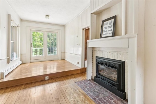 16 River Rd, Hanover, MA 02339 - unfurnished living room with hardwood / wood-style flooring, a brick fireplace, crown molding, and a baseboard heating unit