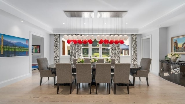 dining room with baseboards, wood finished floors, and recessed lighting