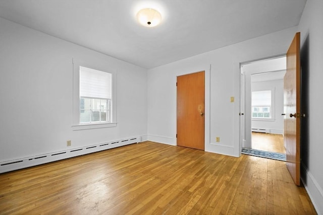58 Huntington Ave, Dartmouth, MA 02747 - unfurnished bedroom featuring light wood-style flooring and a baseboard radiator