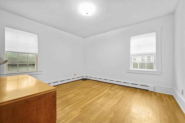 58 Huntington Ave, Dartmouth, MA 02747 - empty room with light wood finished floors, a baseboard heating unit, and baseboards
