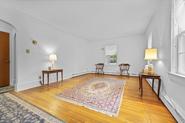 58 Huntington Ave, Dartmouth, MA 02747 - sitting room with arched walkways, wood finished floors, and baseboard heating