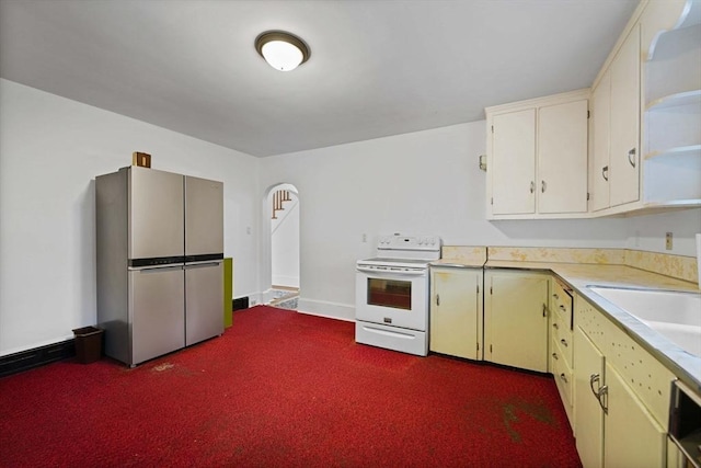 58 Huntington Ave, Dartmouth, MA 02747 - kitchen with freestanding refrigerator, electric stove, light countertops, dark carpet, and open shelves