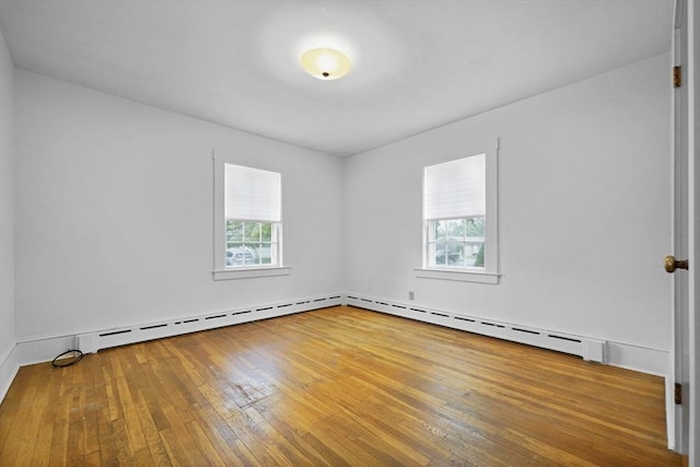 58 Huntington Ave, Dartmouth, MA 02747 - empty room featuring healthy amount of natural light, hardwood / wood-style flooring, and a baseboard radiator