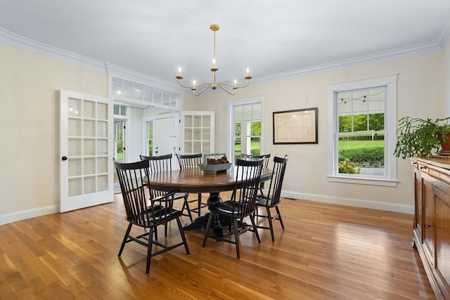 81 Hanover Rd, Carlisle, MA 01741 - dining room featuring a chandelier, baseboards, ornamental molding, light wood finished floors, and french doors