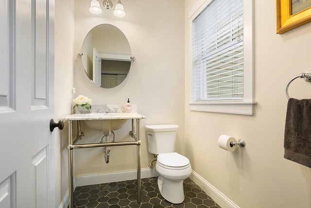 81 Hanover Rd, Carlisle, MA 01741 - bathroom with toilet, baseboards, and healthy amount of natural light