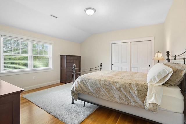 81 Hanover Rd, Carlisle, MA 01741 - bedroom with vaulted ceiling, baseboards, light wood-style floors, and a closet