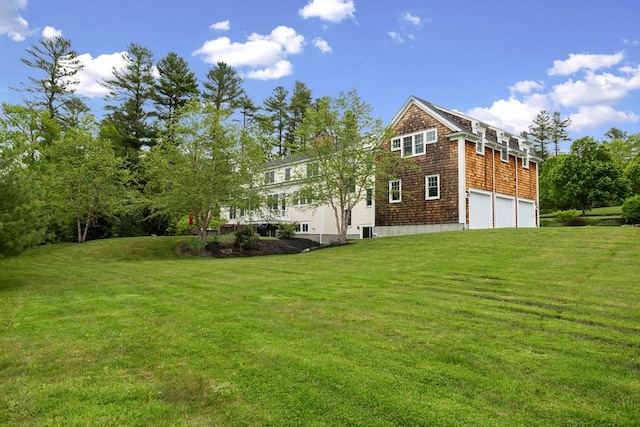 81 Hanover Rd, Carlisle, MA 01741 - rear view of property featuring a garage and a lawn
