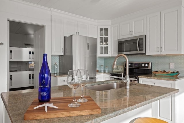 kitchen featuring white cabinets, backsplash, and stainless steel appliances