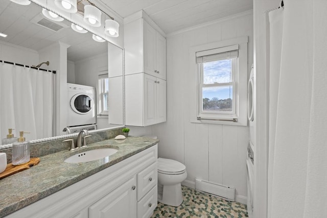 bathroom with vanity, toilet, ornamental molding, and stacked washer / dryer