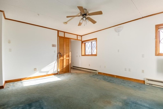 carpeted spare room featuring baseboards, ceiling fan, a baseboard radiator, and crown molding