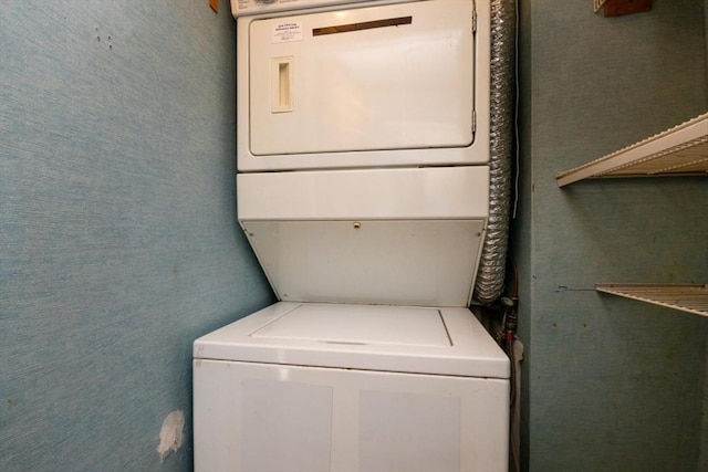 laundry area featuring laundry area and stacked washer / drying machine