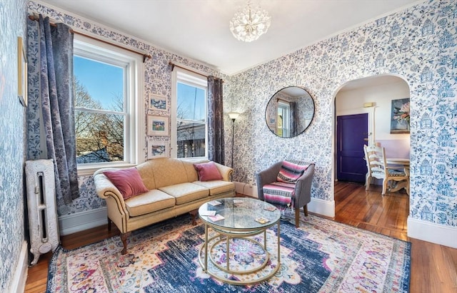 living room featuring an inviting chandelier and hardwood / wood-style flooring