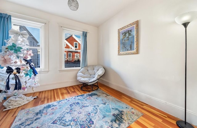 sitting room with wood-type flooring