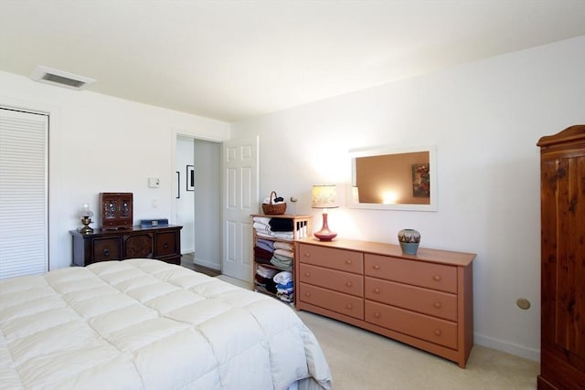 bedroom featuring visible vents, light colored carpet, and baseboards