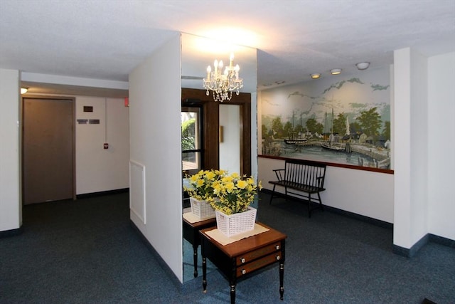 hallway with a chandelier, baseboards, and carpet floors