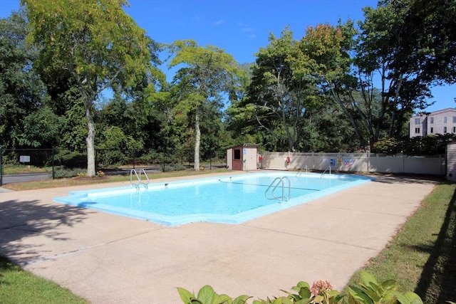 view of swimming pool with a patio area, fence, and a fenced in pool
