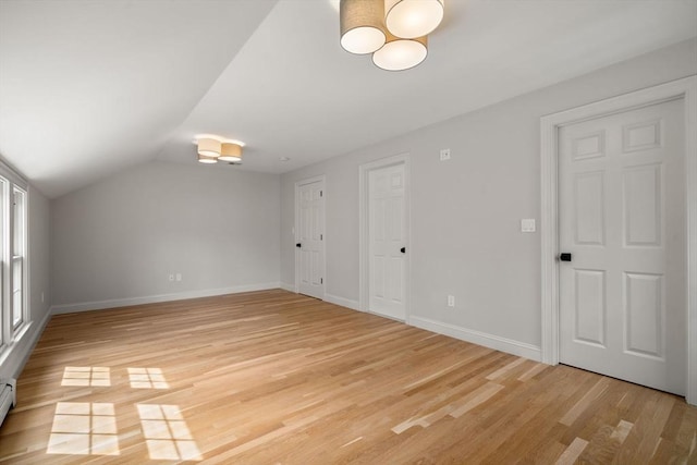 443 Great Plain Ave, Needham, MA 02492 - bonus room with light wood finished floors, baseboards, vaulted ceiling, baseboard heating, and a chandelier