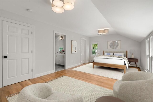443 Great Plain Ave, Needham, MA 02492 - bedroom with wood finished floors, lofted ceiling, ensuite bathroom, baseboards, and a baseboard radiator