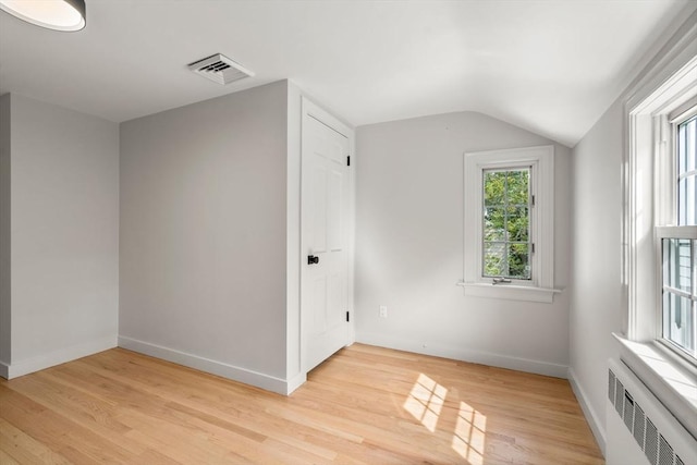 443 Great Plain Ave, Needham, MA 02492 - bonus room featuring radiator heating unit, light wood-type flooring, vaulted ceiling, and baseboards