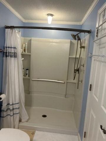 56 Granby Hts Unit 56, Granby, MA 01033 - bathroom with crown molding, a stall shower, toilet, and tile patterned floors