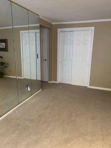 56 Granby Hts Unit 56, Granby, MA 01033 - unfurnished bedroom featuring ornamental molding, carpet floors, baseboards, and multiple closets