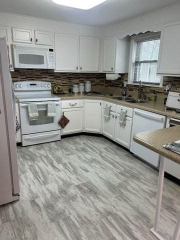 56 Granby Hts Unit 56, Granby, MA 01033 - kitchen featuring white appliances, a sink, white cabinetry, tasteful backsplash, and light countertops