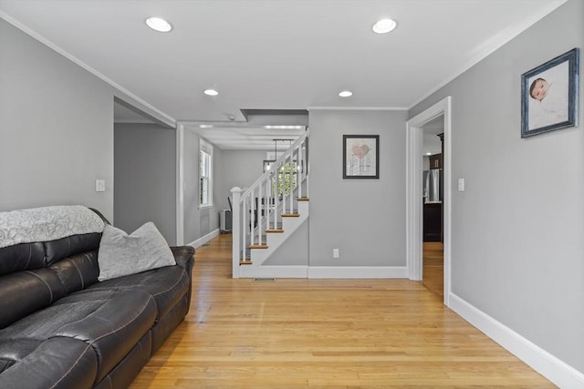 12 Willow St, Wakefield, MA 01880 - living area with recessed lighting, stairway, light wood finished floors, and crown molding