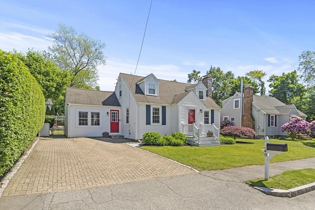 12 Willow St, Wakefield, MA 01880 - cape cod house with a front yard, a shingled roof, and driveway