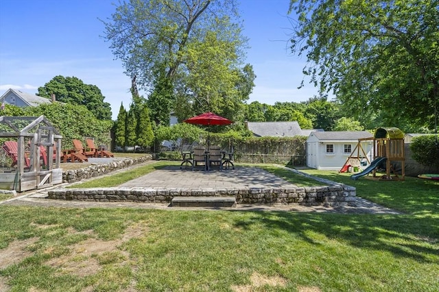 12 Willow St, Wakefield, MA 01880 - view of yard featuring a playground, a patio area, and a shed