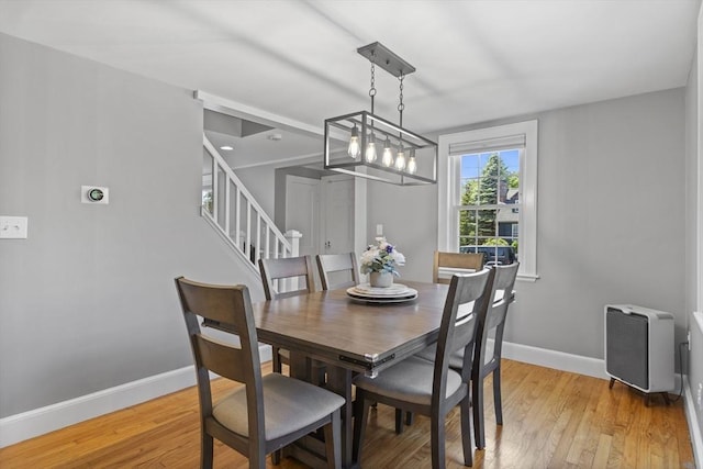 12 Willow St, Wakefield, MA 01880 - dining room with stairs, light wood finished floors, and a chandelier